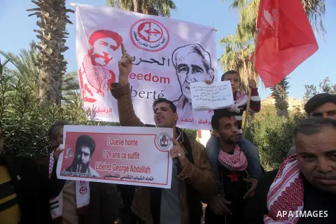 Palestinian supporters of the Popular Front for the Liberation of Palestine (PFLP) take part in a protest outside the French Cultural Center calling for the release of Lebanese militant Georges Ibrahim Abdallah (portrait...