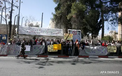 Palestinians take part in a protest against the opening project of the street number (4) in the middle of Bet Sfafa neighbourhood, which is for settlement project services, in front of Jerusalem municipality, in Jerusale...