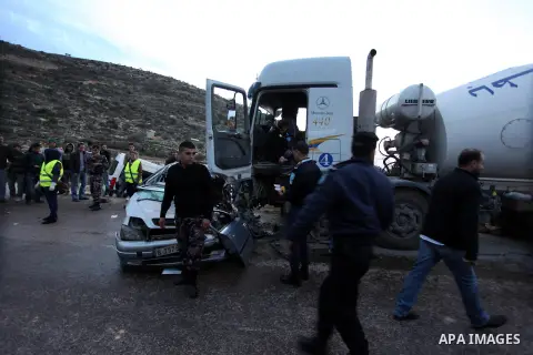 Members of Palestinian civil defense inspect crashed cars in the West Bank city of Ramallah on January 24, 2013. Three Palestinians dead and three injured in an accident between a car and a Truck on the road of Dayr Ibzi...