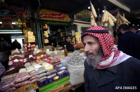 A Palestinian man walks at Al-Zawiya market in Gaza city on Jan. 26, 2013. Photo by Ashraf Amra