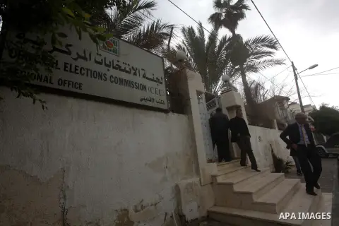 Palestinians walk pass the Election Commissioner office in Gaza city, on Jan. 30, 2013. Hamas Prime Minister Ismail Haniya called Central Elections Commission chief Hanna Nasser and invited him to Gaza for talks about vo...