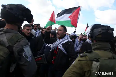 Israeli security forces detain a Palestinian activist during a protest against Jewish settlements near the West Bank village of Burin, Saturday, Feb. 2, 2013. Israeli troops fired tear gas and stun grenades at rock-throw...
