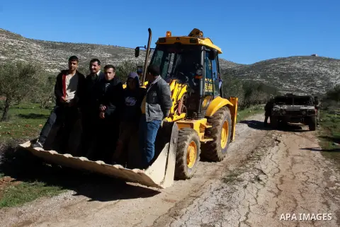 Israeli soldiers prevent Palestinian workers from repairing the road in Awarta village, south in the West Bank city of Nablus on Feb. 04, 2013. Israeli forces on Sunday reopened several roads in Nablus which had been clo...