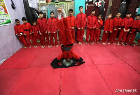 Palestinian children practise Kungfu during martial arts training class at the Red Dragon School in Beit Lahiya Town, northern Gaza, Palestine, Feb. 04, 2013. Over 10 clubs like Red Dragon Scholl teach martial arts in Ga...