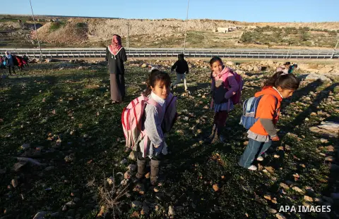 Palestinian students walk through a sewage tunnel to get to school near the West Bank village of Jaba' , southern Jinin, on Feb. 05, 2013. Students try to avoid cross the main road traffic which caused many accidents and...