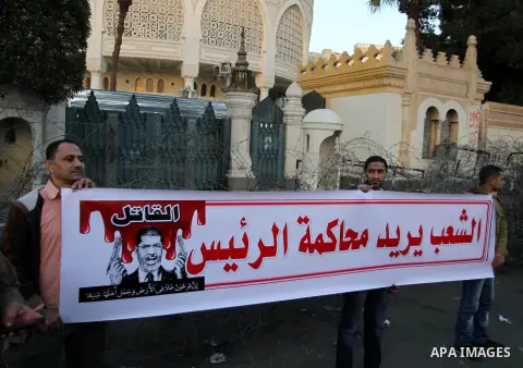 Egyptian anti-government protestors shout political slogans as they wave their national flag and banners during a march towards Cairo's landmark Tahrir square during a demonstration against Egypt's President Mohamed Mors...