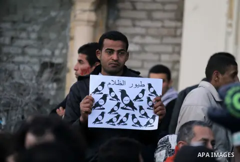 Egyptian anti-government protestors shout political slogans as they wave their national flag and banners during a march towards Cairo's landmark Tahrir square during a demonstration against Egypt's President Mohamed Mors...
