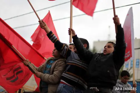 Palestinian supporters of Palestinian People's Party take part in a demonstration in solidarity with hunger-striking Palestinian prisoners held by Israel, demanding their release in Gaza city on Feb, 10, 2013. Photo by A...
