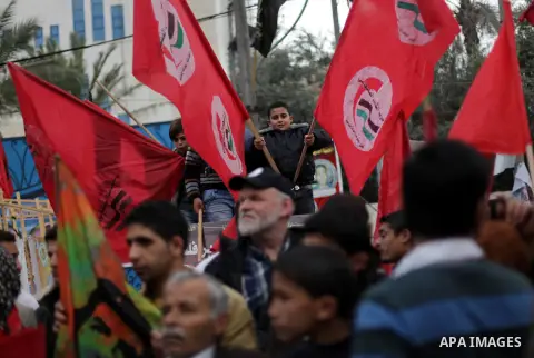 Palestinian supporters of Palestinian People's Party take part in a demonstration in solidarity with hunger-striking Palestinian prisoners held by Israel, demanding their release in Gaza city on Feb, 10, 2013. Photo by A...