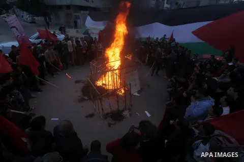 Palestinian supporters of Palestinian People's Party burn a symbolic jail during a demonstration in solidarity with hunger-striking Palestinian prisoners held by Israel, demanding their release in Gaza city on Feb, 10, 2...