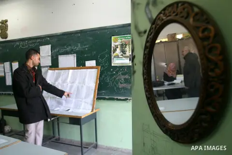 A Palestinian man looks for his name on voter lists put up on a wall inside a school in the southern Gaza strip town of Rafah on February 11, 2013. The Palestinian Central Election Commission (CEC) began on Monday regist...