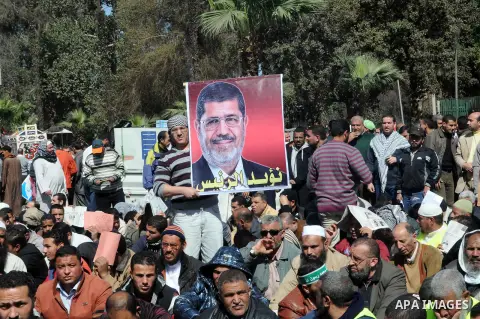 Supporters of Islamist Egyptian President take part in a protest outside the University of Cairo to denounce violence after weeks of bloody protests between police and anti-Morsi protesters on February 15, 2013. The Isla...
