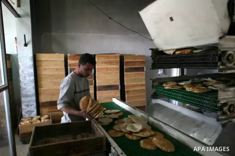 A Palestinian baker prepares bread at his traditional bakery in Rafah, southern Gaza Strip on Feb. 17, 2013. Photo by Eyad Al Baba