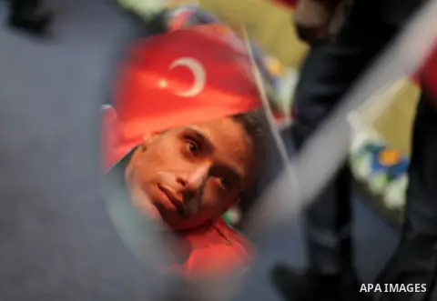 Palestinians carry Turkish and Palestinian flags, during the graduation ceremony of the first batch of the project titled "Erada" in the Islamic University in Gaza city on Feb. 17, 2013. The project funded by the Turkish...