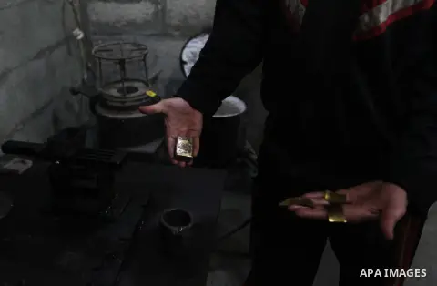 A Palestinian jeweller displays melted gold at his workshop in Gaza city on February 18, 2013. Photo by Ashraf Amra