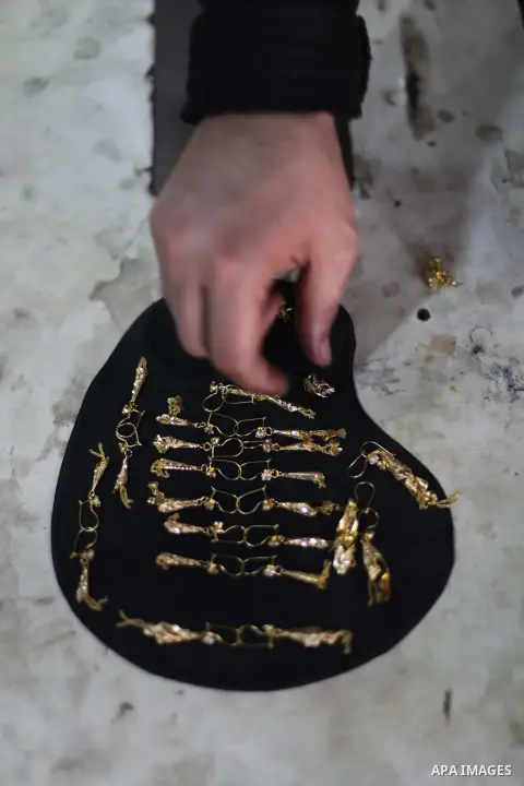 A Palestinian jeweller displays gold earrings at his workshop in Gaza city on February 18, 2013. Photo by Ashraf Amra