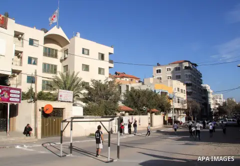 Palestinian youths play football match in front of Red Cross headquarter in Gaza city during a sit-in in support of prisoners on hunger strike in Israeli prisons on February 20, 2013. Some 800 Palestinians serving time i...