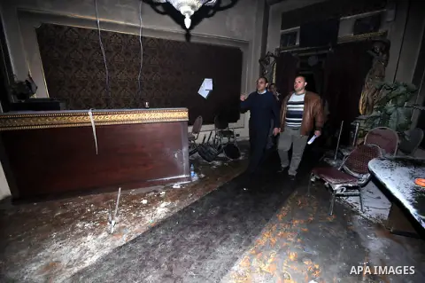 Egyptians inspect the destruction after members of the Black Bloc group torched office tomorrow El- thour party in downtown Cairo on February 22, 2013. Photo by Tareq Gabas