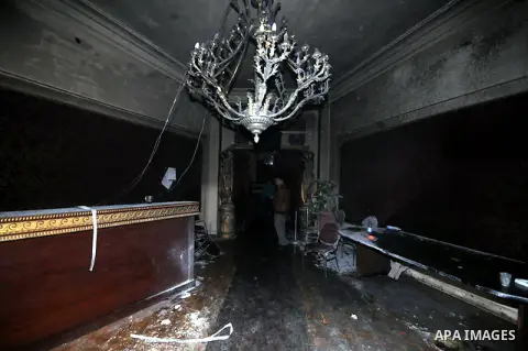 A picture shows the charred remains of Egyptian laywer Ayman Nur's office, chairman of the Ghad El-Thawra Party, after members of the Black Bloc group torched his office in downtown Cairo on February 22, 2013. Photo by T...