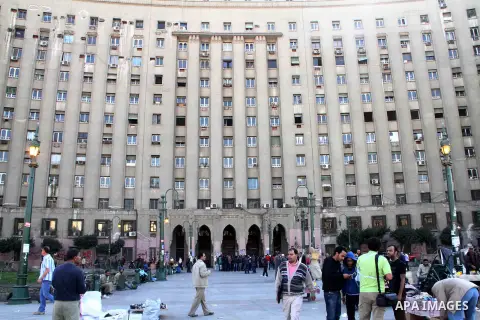 Egyptians walk at al-Tahrir square in front of the Mugamma, Cairo's main administrative building on February 24, 2013 part of a growing campaign of civil disobedience around the country. A group of protesters closed the...