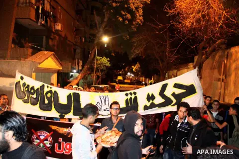 Egyptian protesters gather in front of Governorate building in Giza on February 24, 2013, as they closed its doors part of a growing campaign of civil disobedience around the country. A group of protesters closed the doo...