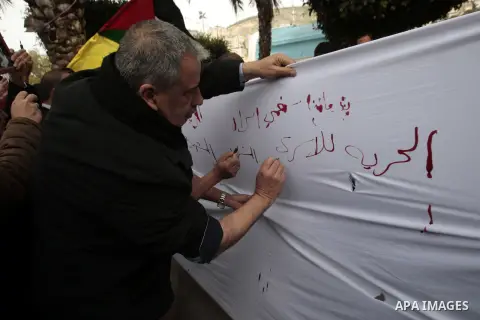 Palestinians write letters in blood on a banner during a demonstration in support of the Palestinian prisoners in Israeli jails, in the city of Nablus, in the occupied West Bank, on February 25, 2013. Protests in support...