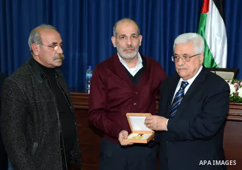 Palestinian President Mahmoud Abbas honors the Martyrs of the Research Center by the Order of Jerusalem in the West Bank city of Ramallah on February 25, 2013. Photo by Thaer Ganaim