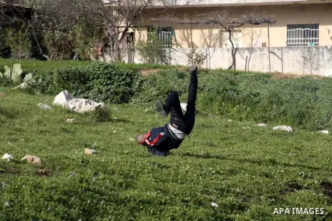 A Palestinian protester falls on the ground during clashes at Hawwara military checkpoint near the West Bank city of Nablus, on February 25, 2013 following the death of a Palestinian prisoner held in Israel. Palestinians...
