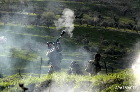 An Israeli border policeman fires a tear gas canister at Palestinian protesters during clashes at Hawwara military checkpoint near the West Bank city of Nablus, on February 25, 2013 following the death of a Palestinian p...