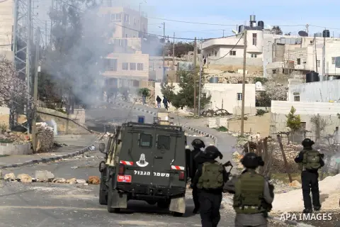 Israeli border police stand apposite Palestinian protesters during clashes in the village of Saair near the West Bank city of Hebron, on February 25, 2013. Palestinians attended the funeral of Arafat Jaradat, 30, whose d...