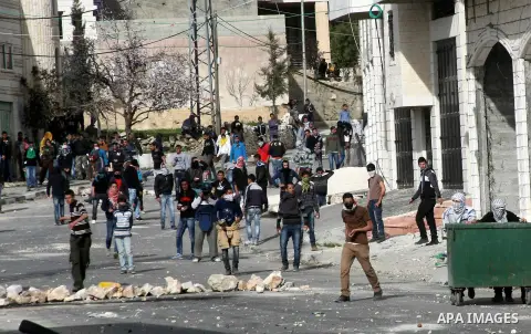 Palestinian protesters throw stones at Israeli border police during clashes in the village of Saair near the West Bank city of Hebron, on February 25, 2013. Palestinians attended the funeral of Arafat Jaradat, 30, whose...