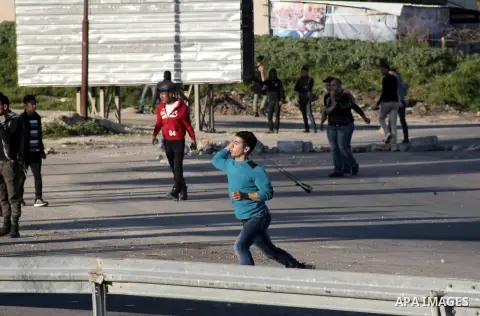 Palestinian protesters throw stones at Israeli security forces during clashes at Hawwara military checkpoint near the West Bank city of Nablus on February 26, 2013. Increased protests in the West Bank after the killing o...