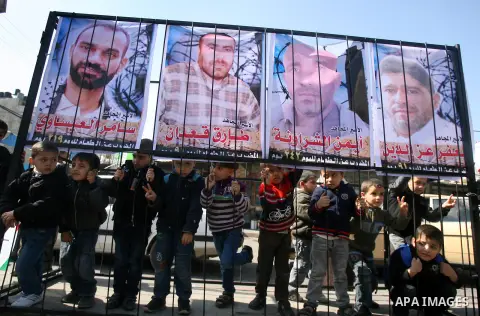 Palestinian children take part in a protest against the death of a Palestinian detainee in an Israeli jail, in Rafah city in the southern Gaza Strip on Feb. 27, 2013. Palestinian officials on Saturday demanded an interna...