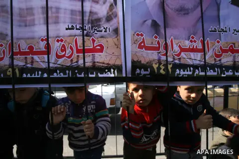 Palestinian children take part in a protest against the death of a Palestinian detainee in an Israeli jail, in Rafah city in the southern Gaza Strip on Feb. 27, 2013. Palestinian officials on Saturday demanded an interna...