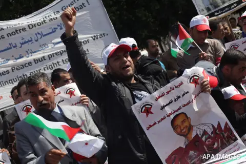 Demonstrators from the Palestinian factions take part in a protest against the death of a Palestinian detainee in an Israeli jail, in front of the Erez crossing into Israel near the northern Gaza Strip town of Beit Hanun...