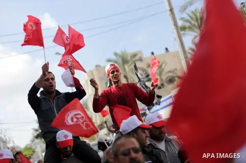 Demonstrators from the Palestinian factions take part in a protest against the death of a Palestinian detainee in an Israeli jail, in front of the Erez crossing into Israel near the northern Gaza Strip town of Beit Hanun...