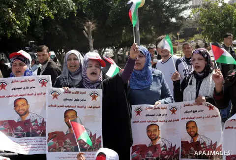 Demonstrators from the Palestinian factions take part in a protest against the death of a Palestinian detainee in an Israeli jail, in front of the Erez crossing into Israel near the northern Gaza Strip town of Beit Hanun...