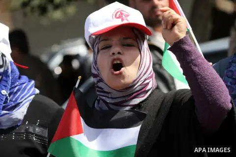 Demonstrators from the Palestinian factions take part in a protest against the death of a Palestinian detainee in an Israeli jail, in front of the Erez crossing into Israel near the northern Gaza Strip town of Beit Hanun...