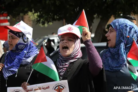Demonstrators from the Palestinian factions take part in a protest against the death of a Palestinian detainee in an Israeli jail, in front of the Erez crossing into Israel near the northern Gaza Strip town of Beit Hanun...