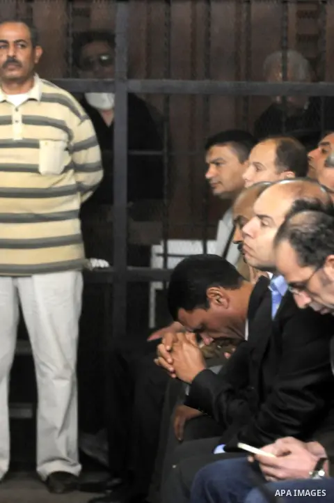 Egyptian businessman Ahmed Ezz stands behind bars at the Giza Criminal Court, on march 06, 2013. According to prosecutors, Ezz, a close ally of former President Hosni Mubarak and a former leading official at his dissolve...