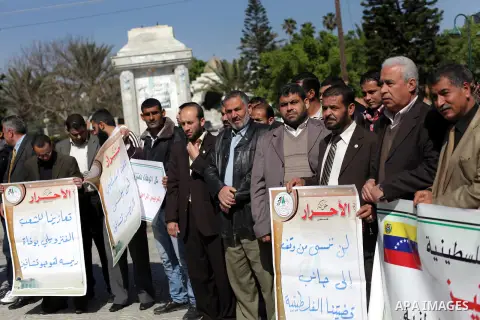 Palestinian factions hold portraits of late Venezuelan president Hugo Chavez during a rally in the Square of the unknown Soldier in Gaza city on march 07, 2013. Chavez died on 05 March from complications related to cance...