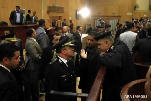 Judges of the Port Said Criminal Court, holding a hearing in Cairo for security reasons, rules in the case of last year's soccer violence in Port Said which left over 70 dead in Cairo, Egypt, Saturday, March 9, 2013. An...