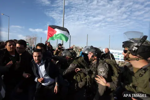 Israeli soldiers prevent the progress of a symbolic wedding party towards the Israeli constructed controversial separation barrier close to the Israeli manned checkpoint of Hezma in the Israeli occupied West Bank, betwee...