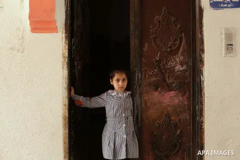 A Palestinian girl stands in front of her home in al-Shatee refugees camp western Gaza city, on march 13, 203. Israel is trying to go through the UN to change the legal nature of Palestinian refugees and deny "refugee" s...