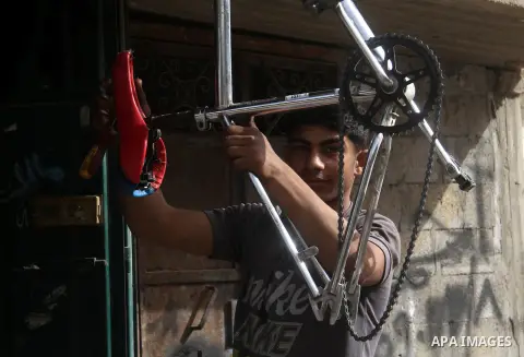 Khamis al-Burdini, 15, a Palestinian youth repairs bicycles at his workshop in Gaza city, on March 13, 2013. al-Burdini opened his workshop 3 years ago after leaving his school to provide his poor family . Photo by Ezz a...