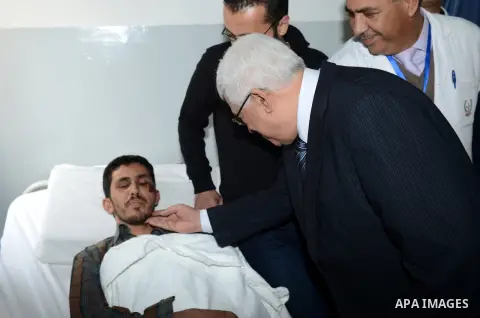 Palestinian President Mahmoud Abbas visits the wounded pilgrims in the hospital of Salt, in Amman on March 17, 2013. Fifteen Palestinians returning from a minor pilgrimage in Saudi Arabia were killed and 38 others were i...
