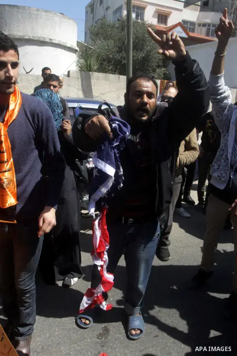 Palestinians burn an American flag during a protest in Gaza City against US President Barack Obama's visit on March 20, 2013. Obama is visiting Israel and the Palestinian Territories for the first time as US president, o...