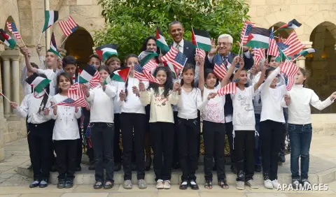 Palestinian President Mahmud Abbas, US President Barack Obama and Bethlehem Mayor Vera Baboun greet Palestinian children after touring the Church of the Nativity, built on the site where tradition says Jesus was born, in...