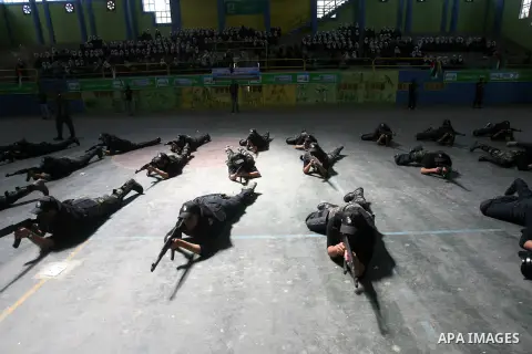Palestinian students take part in a military-style graduation ceremony in Rafah in the southern Gaza Strip March 28, 2013. The military-style exercise in the 138 Hamas-run high schools in Gaza was part of a program sanct...
