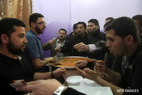 Palestinian former prisoners Hamouda Salah and Radwan Abu Turki, sell Kunafa at their sweet store in Gaza city on March 29, 2013. Salah and Abu Turki was released by Israel as part of the Gilad Shalit prisoner exchange a...
